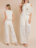 Woman wearing a white lace outfit on a beige background