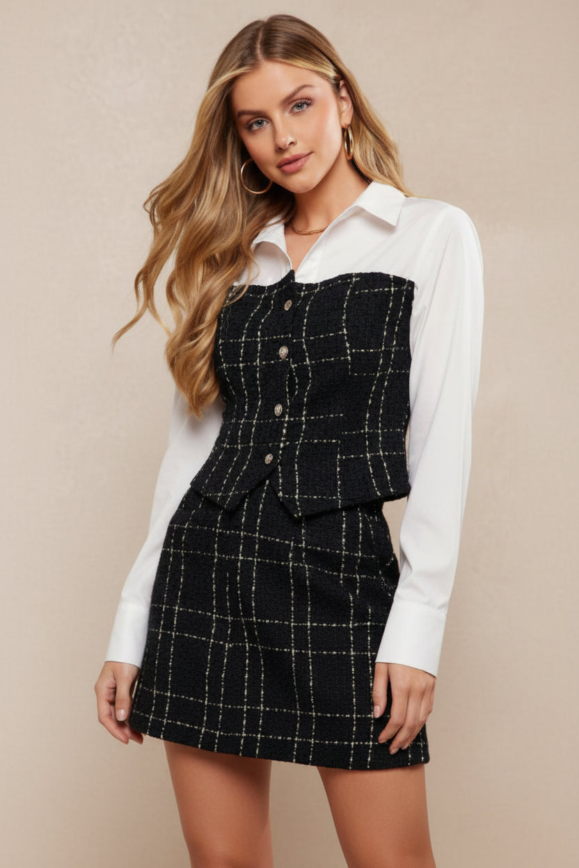 Woman wearing a black and white checkered outfit with a plain background