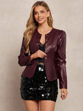 Woman wearing a burgundy leather jacket over a black sequin dress on a beige background