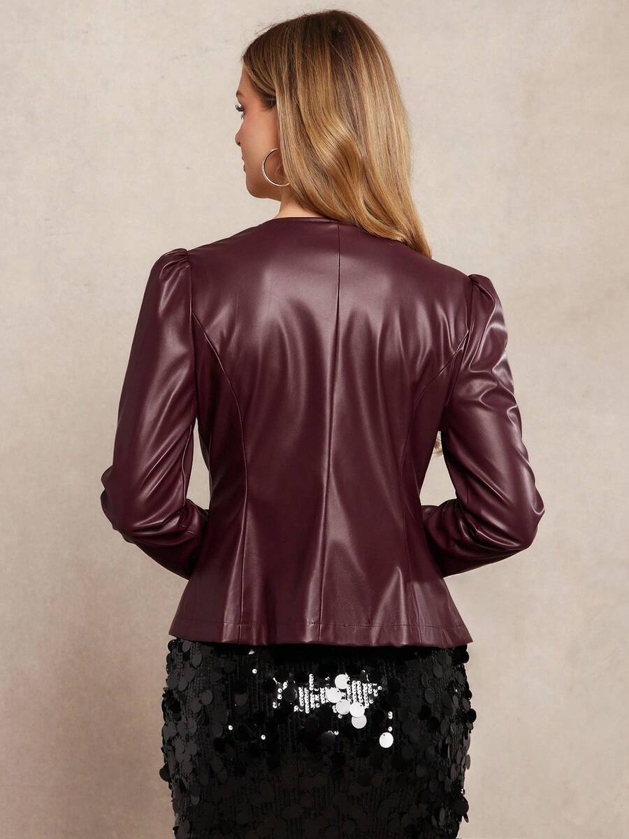 Woman wearing a burgundy leather jacket with a beige background