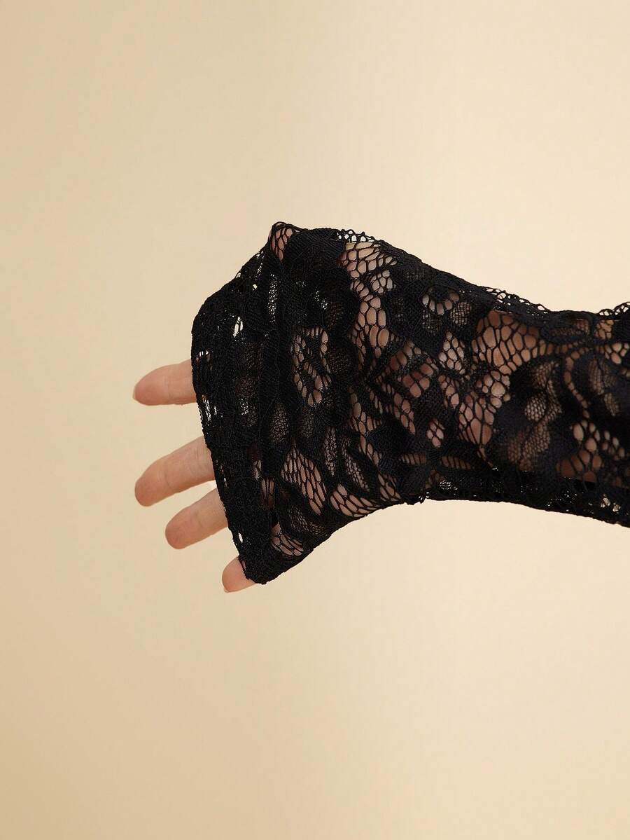 Black lace glove on a beige background