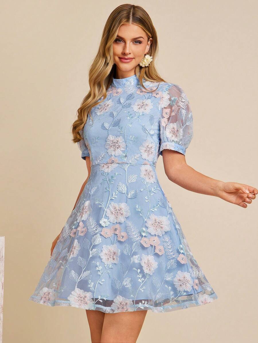 Woman wearing a blue floral dress against a beige background